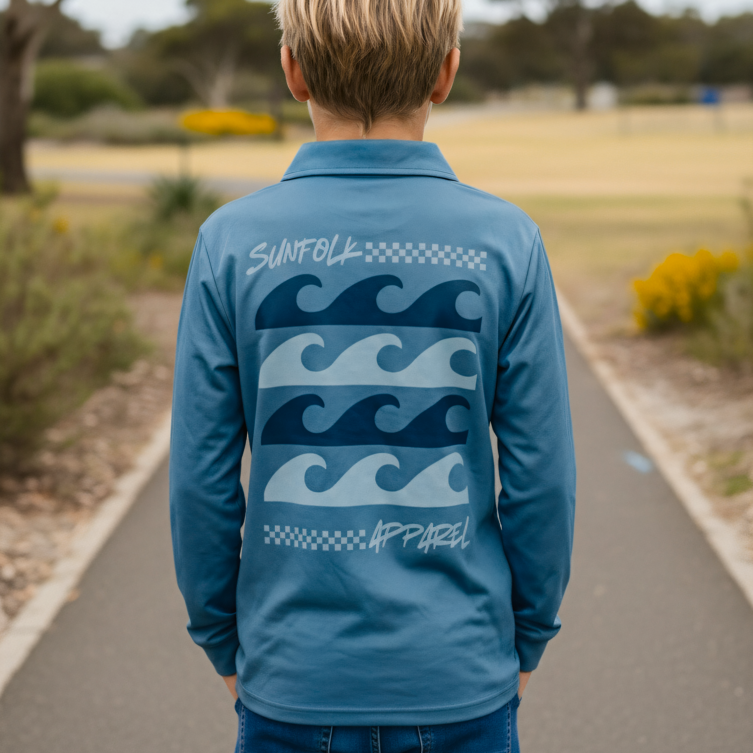 Person wearing a blue long-sleeve shirt with wave design outdoors